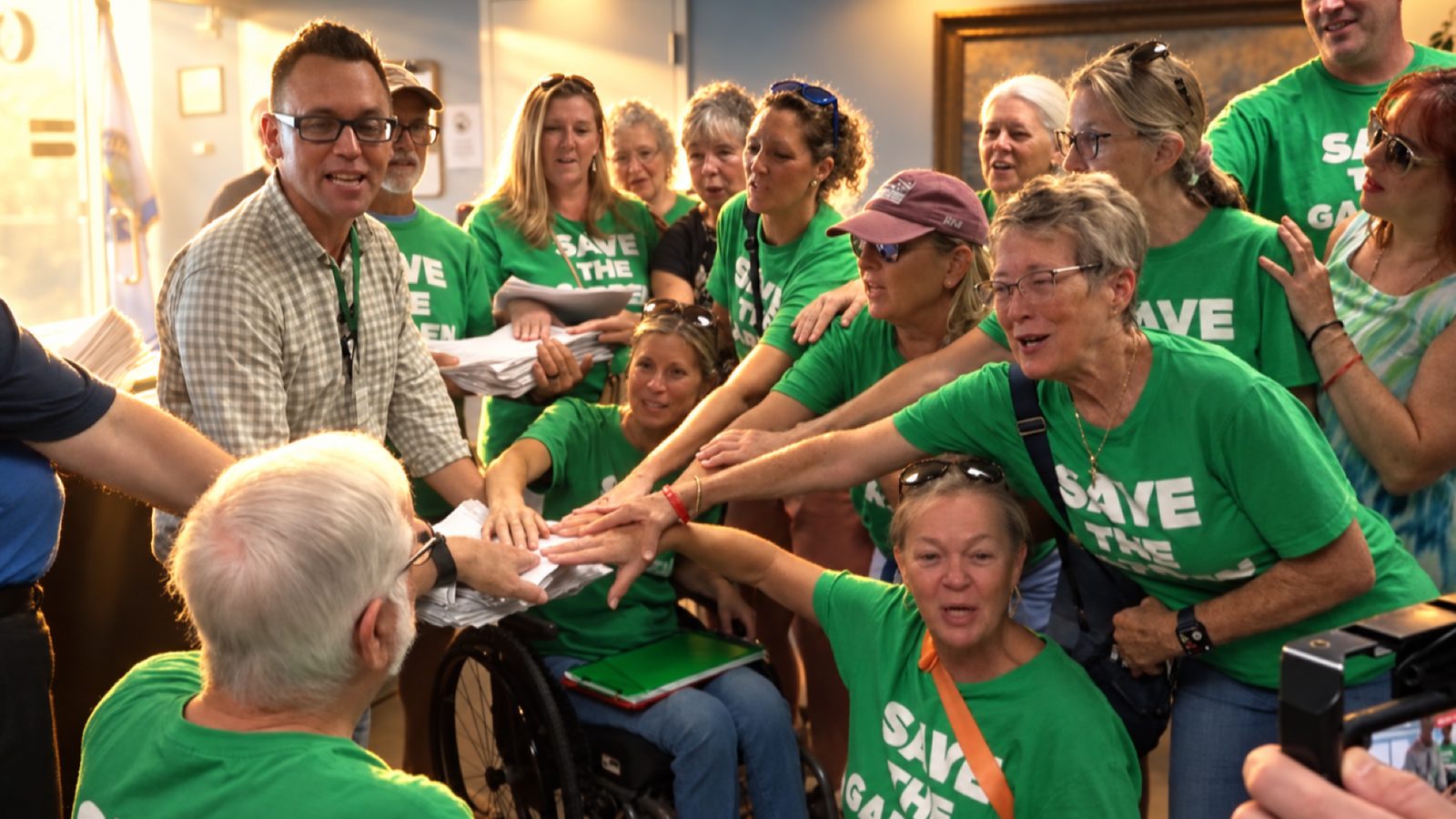 Save the Garden volunteers turning in stacks of signed petitions